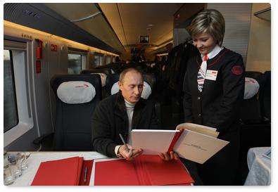 Prime Minister Vladimir Putin returned to Moscow from his trip to St Petersburg on a new high-speed train Sapsan