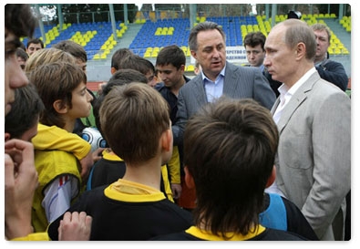 Prime Minister Vladimir Putin speaks with boys from the football team Zhemchuzhina during his visit to the Yug Sport training ground in Sochi