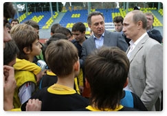 Prime Minister Vladimir Putin speaks with boys from the football team Zhemchuzhina during his visit to the Yug Sport training ground in Sochi