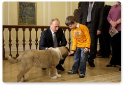 Prime Minister Vladimir Putin chooses a name for his new pet dog recommended by five-year-old Muscovite Dima Sokolov