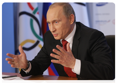 Prime Minister Vladimir Putin speaking with the Russian Olympic team at the Russian House in Vancouver during a video conference at the Olympic Information Centre, Sochi 2014|11 february, 2010|22:26