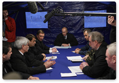 Prime Minister Vladimir Putin holds a meeting of the emergency response team at the Tu-154 crash site