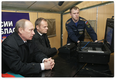 Russian Prime Minister Vladimir Putin holds a conference call with Polish Prime Minister Donald Tusk