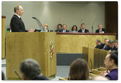 Prime Minister Vladimir Putin delivers a report to the State Duma on government performance