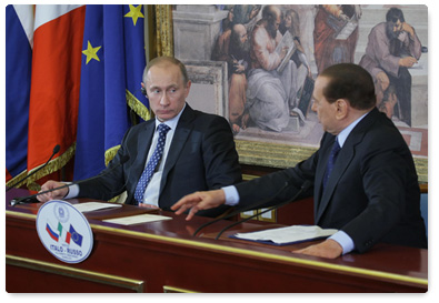 Prime Minister Vladimir Putin and his Italian counterpart Silvio Berlusconi hold a joint news conference following talks in Milan