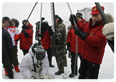 Vladimir Putin and biologists attaching a GPS collar on a polar bear caught in a special trap|29 april, 2010|10:12