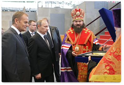 Prime Minister Vladimir Putin and Polish Prime Minister Donald Tusk attend the cornerstone dedication ceremony for the Church of the Resurrection of Christ