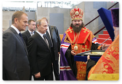 Prime Minister Vladimir Putin and Polish Prime Minister Donald Tusk attend the cornerstone dedication ceremony for the Church of the Resurrection of Christ