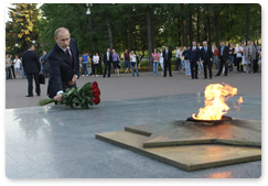 Prime Minister Vladimir Putin lays flowers at the Eternal Flame in Izhevsk, the capital of Udmurtia, and speaks with recent school graduates and young parents