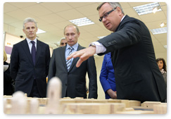 Prime Minister Vladimir Putin examines the new building for the Russian research centre Applied Chemistry in St Petersburg