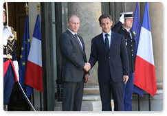 While visiting France, Prime Minister Vladimir Putin meets with French President Nicolas Sarkozy