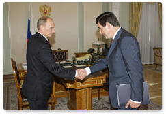 Prime Minister Vladimir Putin meets with head of the Federal Insurance Supervision Service Alexander Koval