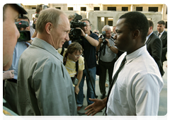 Prime Minister Vladimir Putin meeting with Vasily Krima, born in Guinea-Bissau, during his visit to the construction site for a housing development for servicemen in the Sovetsky district of Volgograd|15 july, 2010|20:26