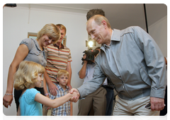 Vladimir Putin speaking to a family in one of the new low-rise residential development in Kotelnikovo after visiting the Gremyachin potassium salt deposits|15 july, 2010|20:58