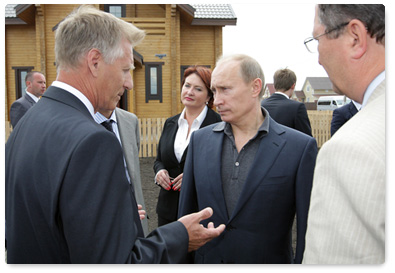 Prime Minister Vladimir Putin tours the construction site of the Solnechny housing complex in the village of Pushkari, Tambov Region