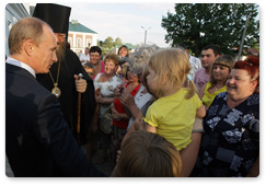 Prime Minister Vladimir Putin visits a church in the village of Tulinovka and assists a farmer in getting a loan