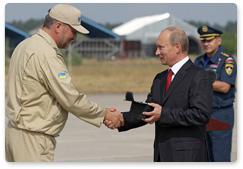 Prime Minister Vladimir Putin presents commemorative gifts to Russian and foreign pilots who took part in emergency operations to extinguish wildfires across Russia this summer