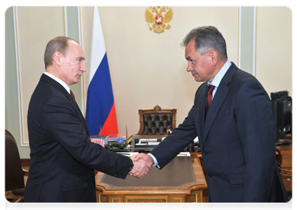 Prime Minister Vladimir Putin presents a State Duma candidate certificate to Civil Defence, Emergencies and Disaster Relief Minister Sergei Shoigu|29 october, 2011|11:09