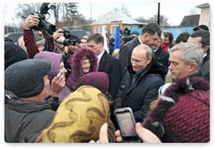 Prime Minister Vladimir Putin meets with local residents during his visit to the village of Golovchino