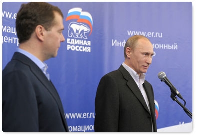 Dmitry Medvedev and Vladimir Putin visit the United Russia party campaign headquarters after the preliminary results were announced