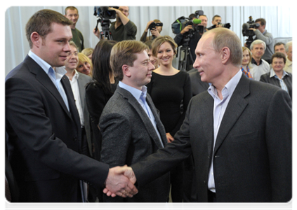 Vladimir Putin and Chairman of the Coordinating Council of the Young Guard Timur Prokopenko in the United Russia party campaign headquarters after the preliminary results were announced|4 december, 2011|23:37