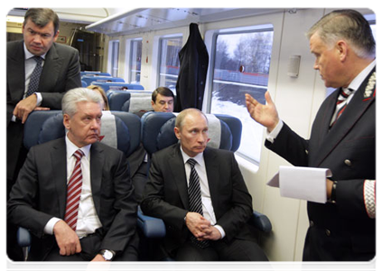 Prime Minister Vladimir Putin continues discussing the development of the Moscow air traffic hub while on a shuttle train from Sheremetyevo Airport back to Moscow|28 march, 2011|20:54