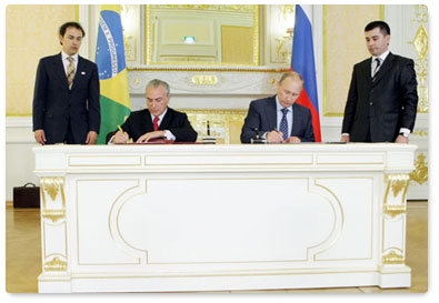 Prime Minister Vladimir Putin and Brazilian Vice President Michel Temer sign a joint statement following the fifth session of the Russian-Brazilian high-level commission on cooperation