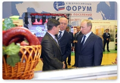 Prime Minister Vladimir Putin visits an exhibition of local farming and food processing products in the village of Atemar during his trip to Mordovia