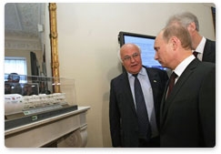 Vladimir Putin examines blueprints for the Orlovsky Tunnel under the Neva River while on a working trip to St Petersburg