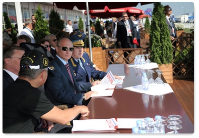 Prime Minister Vladimir Putin attends a flight display at the MAKS 2011 air show