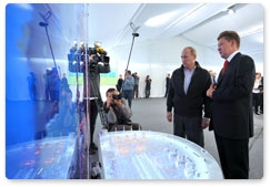 Prime Minister Vladimir Putin meets with Gazprom CEO Alexei Miller following the launch of the Nord Stream gas pipeline