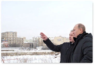 Prime Minister Vladimir Putin and Moscow Mayor Sergei Sobyanin inspect the construction site at the demolished Rossiya Hotel