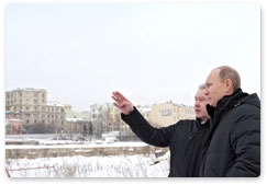 Prime Minister Vladimir Putin and Moscow Mayor Sergei Sobyanin inspect the construction site at the demolished Rossiya Hotel