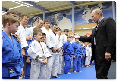 Vladimir Putin attends a class of young judo students and speaks with members of the national judo team during a visit to the Regional Judo Centre in Kemerovo