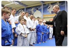 Vladimir Putin attends a class of young judo students and speaks with members of the national judo team during a visit to the Regional Judo Centre in Kemerovo