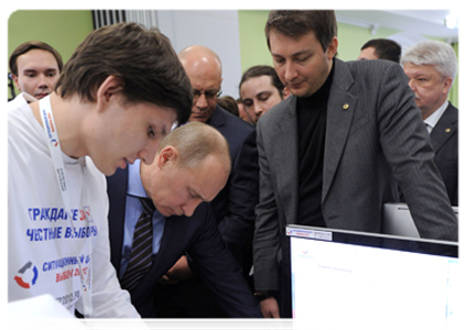 Vladimir Putin reviews the system for the webcam monitoring of polling stations during his visit to the 2012 election monitoring centre|6 march, 2012|15:29